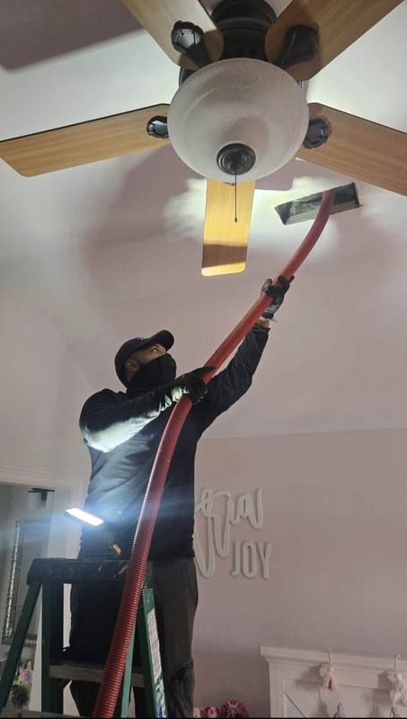 HomePros verified technician cleaning ceiling air duct with professional HEPA equipment